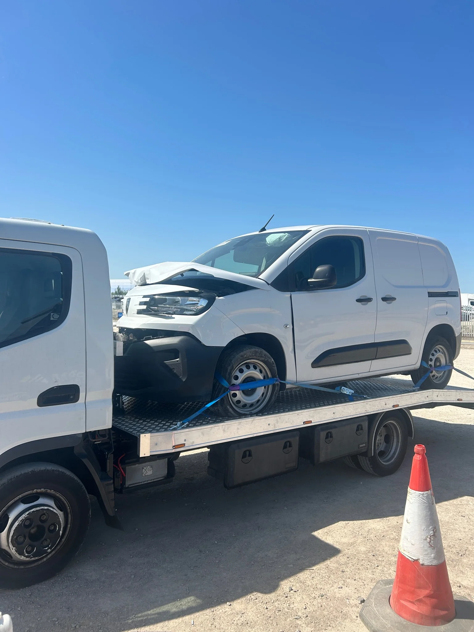Auction vehicle recovery truck collecting salvage vehicle from auction